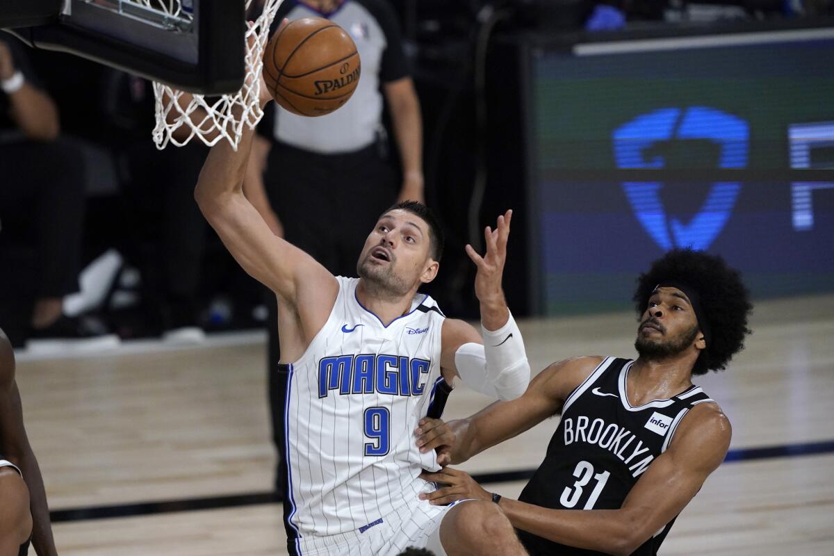 Magic beat Nets 128-118 in restart opener, move up to 7th - The